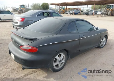 1999 Hyundai Tiburon Fx z USA, uszkodzony, nr VIN KMHJG34F6XU135627